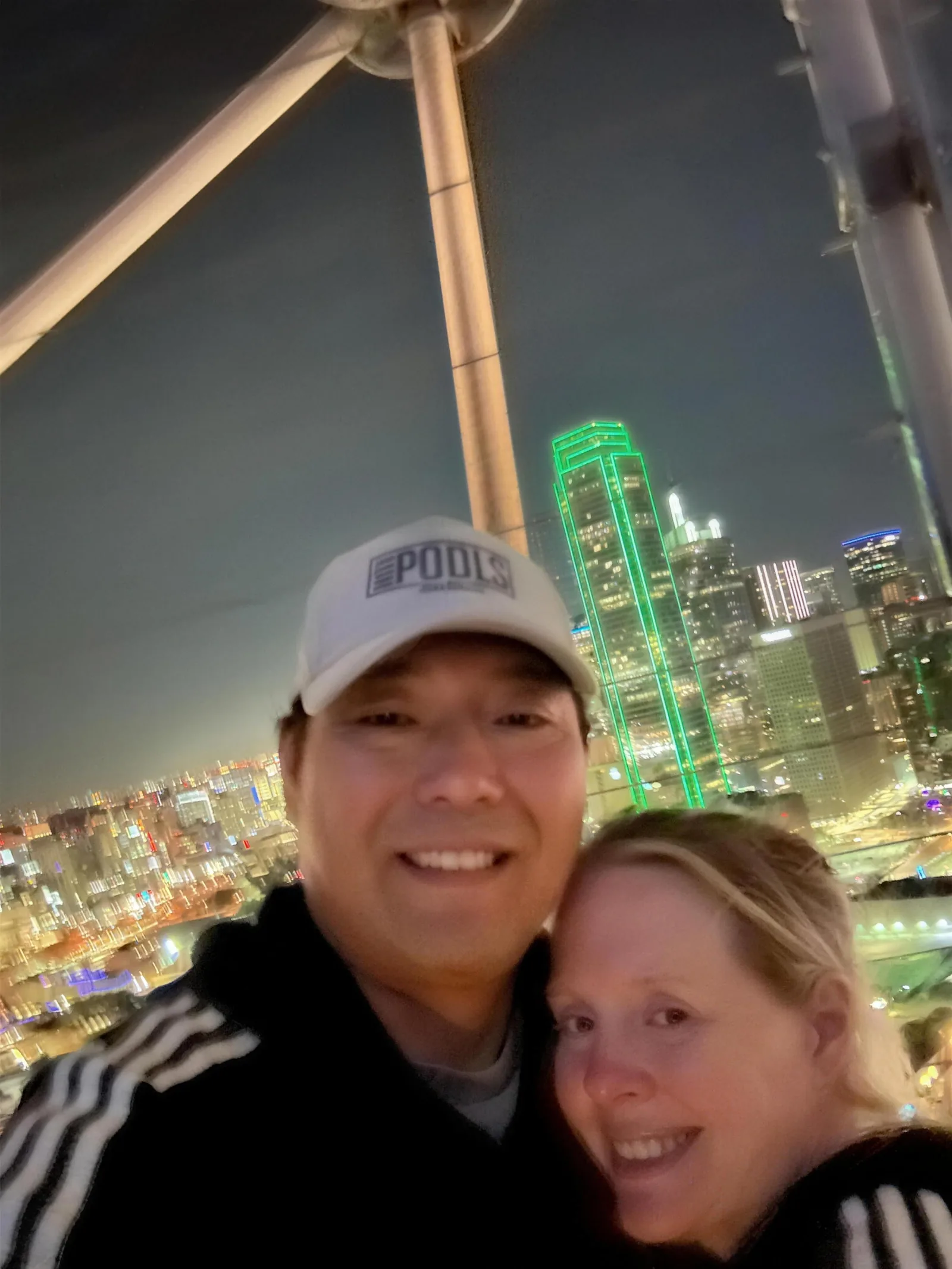 Max and his wife on a Ferris wheel at night