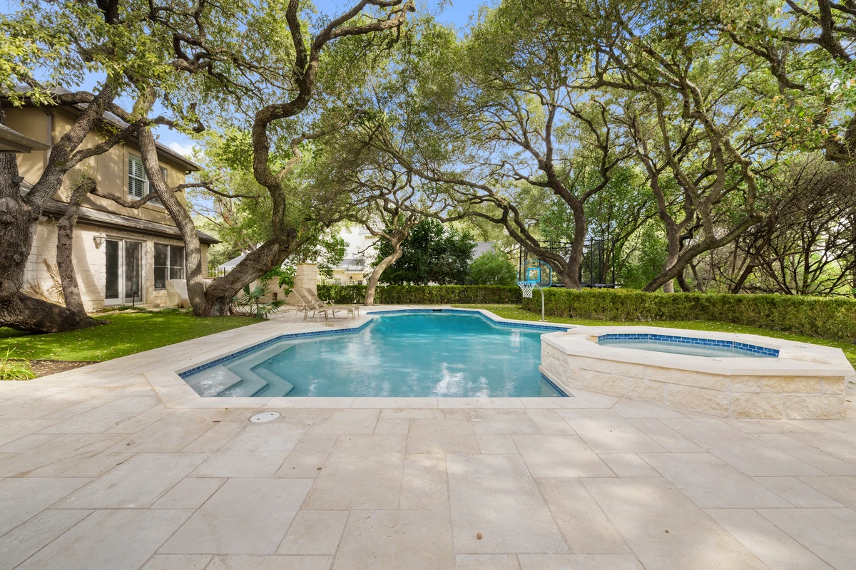 Backyard pool and spa shaded by mature Hill Country oaks