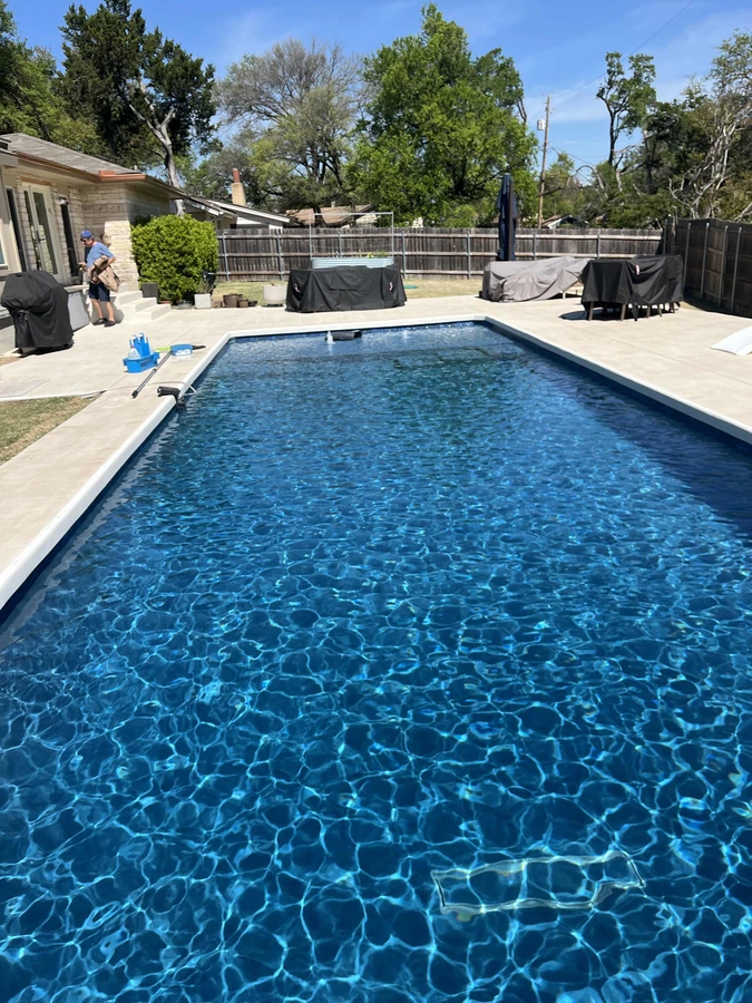 Freshly cleaned and balanced backyard pool after a Max Pools Austin rescue visit