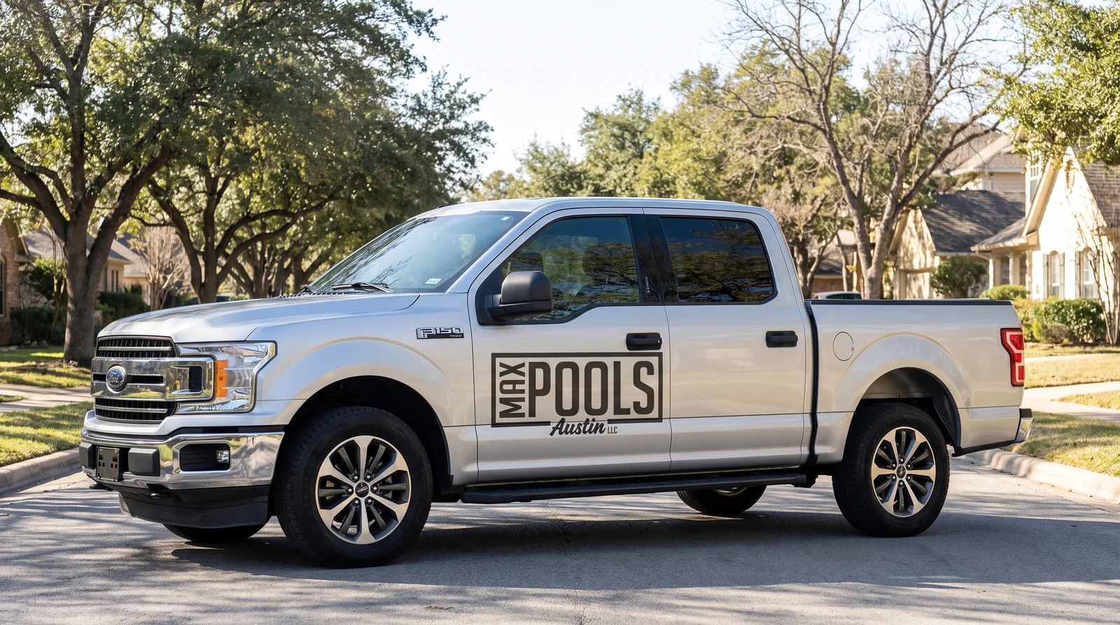 Side profile of the Max Pools Austin branded truck on an Austin street